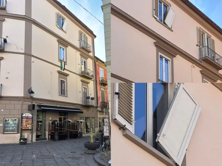 Forte vento colpisce il centro: finestra in bilico sulla strada